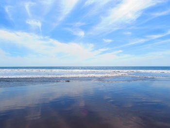 Scenic view of sea against blue sky