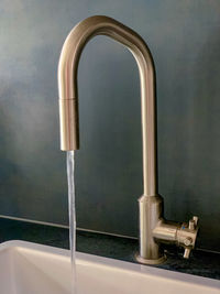 Close-up of faucet in bathroom at home