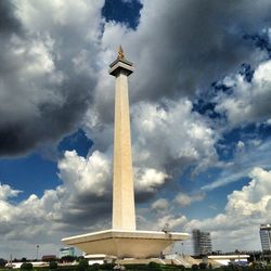 Low angle view of monument against cloudy sky