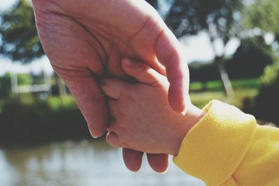 Child holding mothers hand