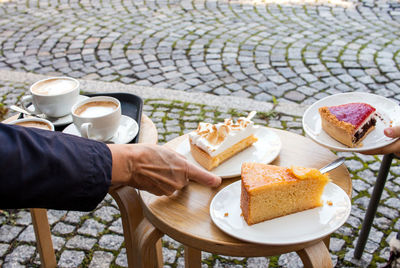 Cakes and coffee are placed on an improvised small table on the street