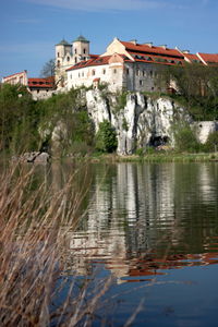 Scenic view of lake by buildings against sky