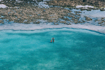 Aerial view of people swimming in sea