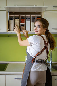 Portrait of female chef at kitchen