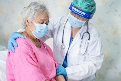 Midsection of women wearing mask