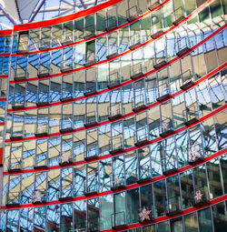 Low angle view of glass building against sky