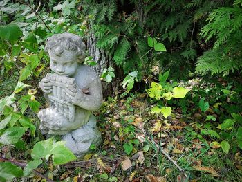 Statue amidst plants