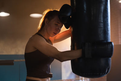 Young woman exercising in gym