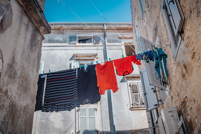 Low angle view of clothes drying on building