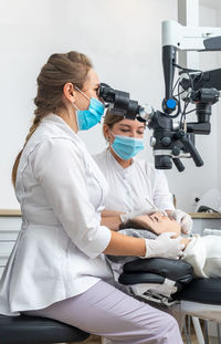 Female doctor examining patient at clinic