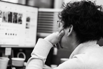 Rear view of businessman looking at computer in office