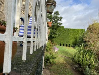 Panoramic shot of cemetery by building against sky