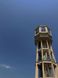 Low angle view of water tower in siófok against sky