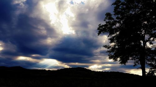 Scenic view of dramatic sky over silhouette landscape