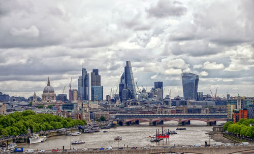 View of cityscape against cloudy sky