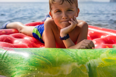 Portrait of cute boy in water