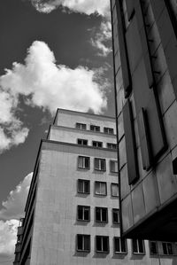 Low angle view of modern building against cloudy sky