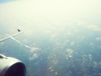 Aerial view of airplane flying in sky