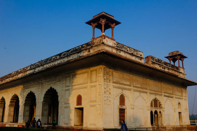 Low angle view of historical building against clear blue sky