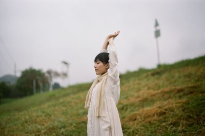 Woman stretching on grassy field