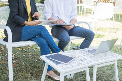 Low section of people working on table