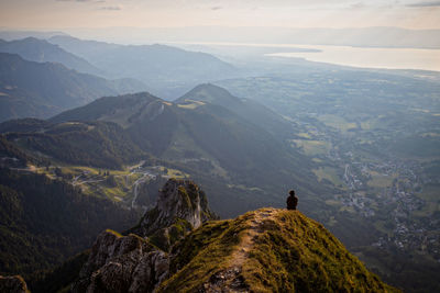 Rear view of man on mountain against sky