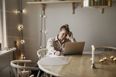 Woman using laptop at home