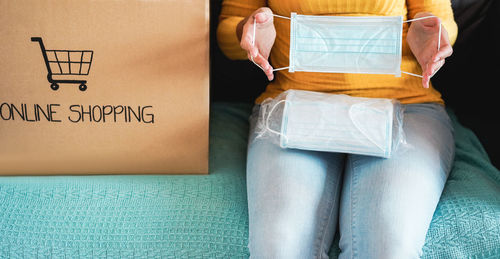 Midsection of woman sitting with text