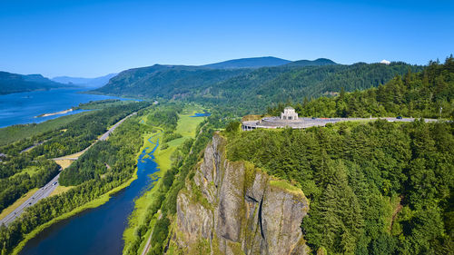 Scenic view of mountains against clear blue sky