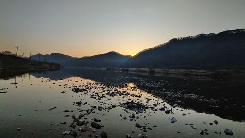 Scenic view of sea against clear sky during sunset