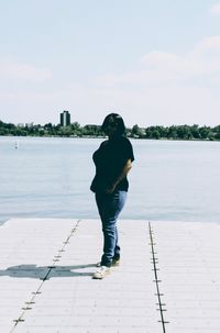 Full length of man standing on shore against sky