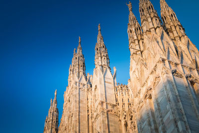 Low angle view of temple building against clear blue sky