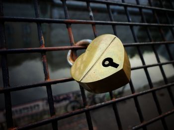 Close-up of padlock on metal railing