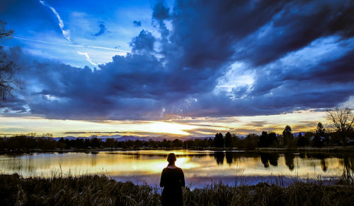 Scenic view of river against dramatic sky