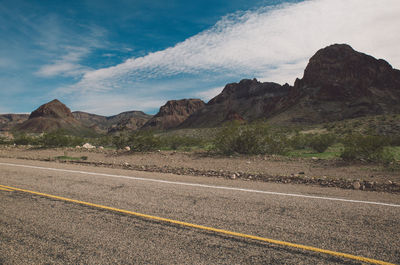 Road by mountains against sky at route 66