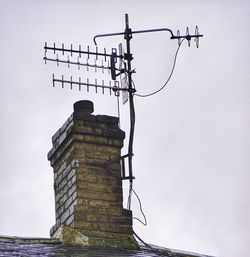 Low angle view of electricity pylon against sky