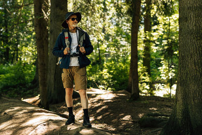 Full length of woman standing in forest