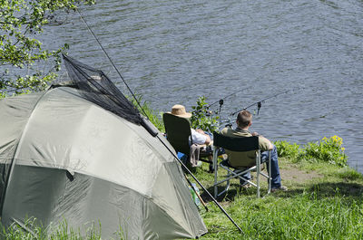 People fishing at lakeshore