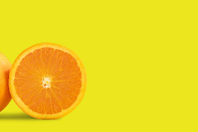 Orange fruit against yellow background