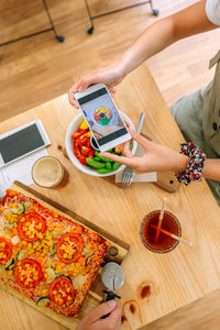High angle view of woman preparing food on table