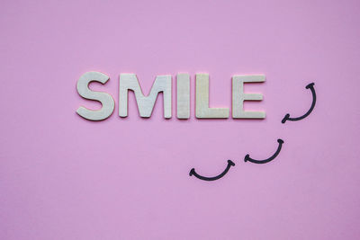 Close-up of text on pink background