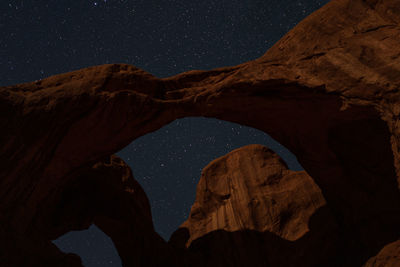 Low angle view of rock formations at night