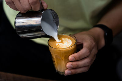 Close-up of hand holding coffee cup