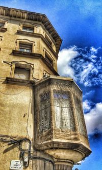 Low angle view of building against cloudy sky