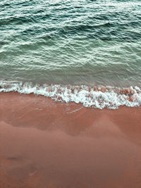 High angle view of waves rushing towards shore