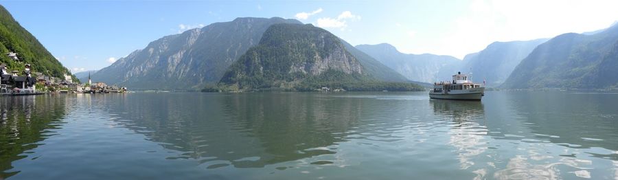 Scenic view of sea and mountains against sky