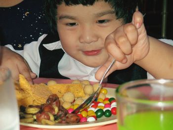 Close-up portrait of baby girl eating food