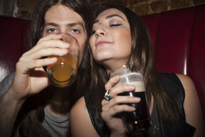 Portrait of young woman drinking glass