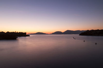 Scenic view of sea against clear sky during sunset