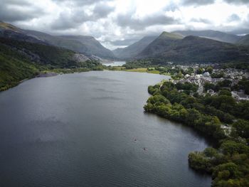 Scenic view of river and mountains against sky